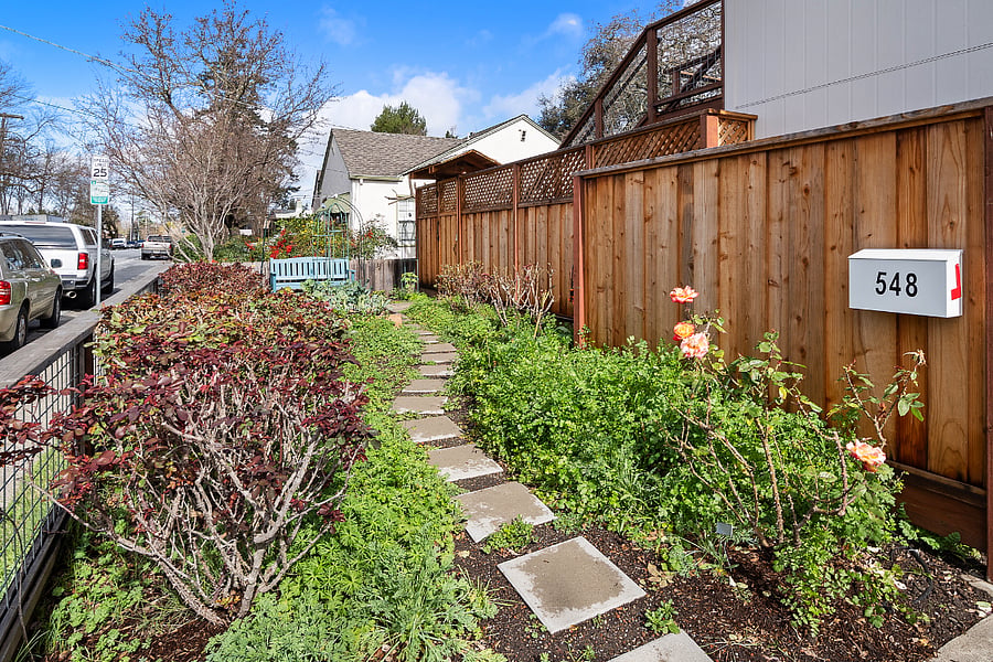 Entry path from street, through garden to private gate.