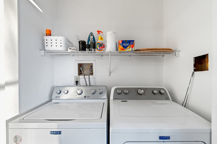 Washer/dryer with iron and ironing board (ironing board is often in one of the bedroom closets)