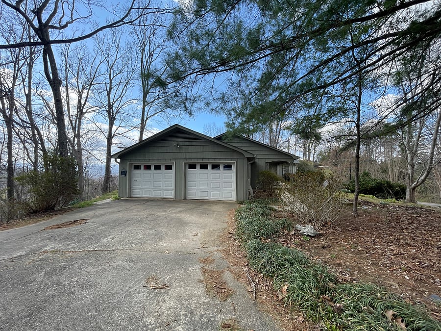 Entrance to home is to the left of the garage. One bay is available for guest use. Plenty of off street parking.