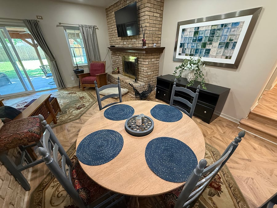 Open Dining and Family Room with wood Burning Fireplace.