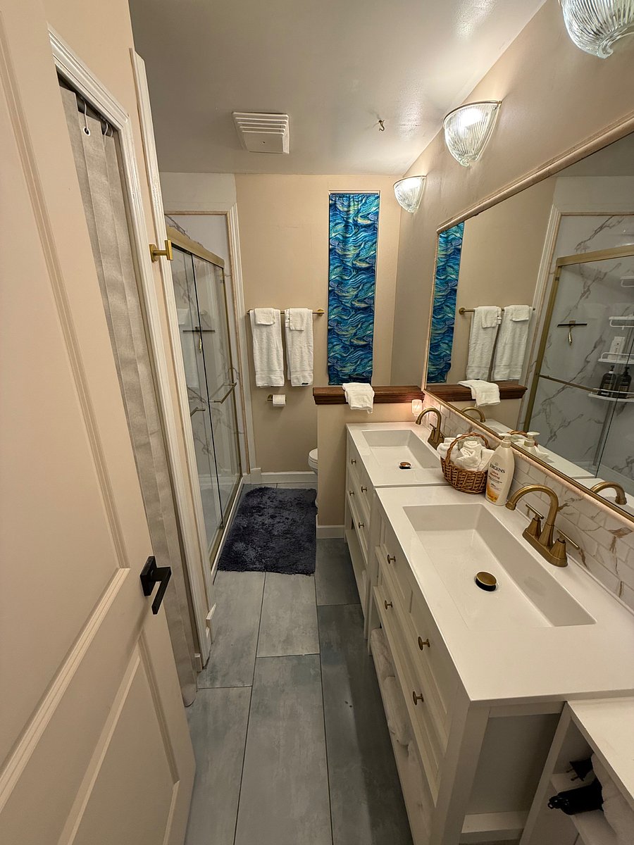 Main Bathroom, All New tiled flooring, Shower, double sinks and toilet.