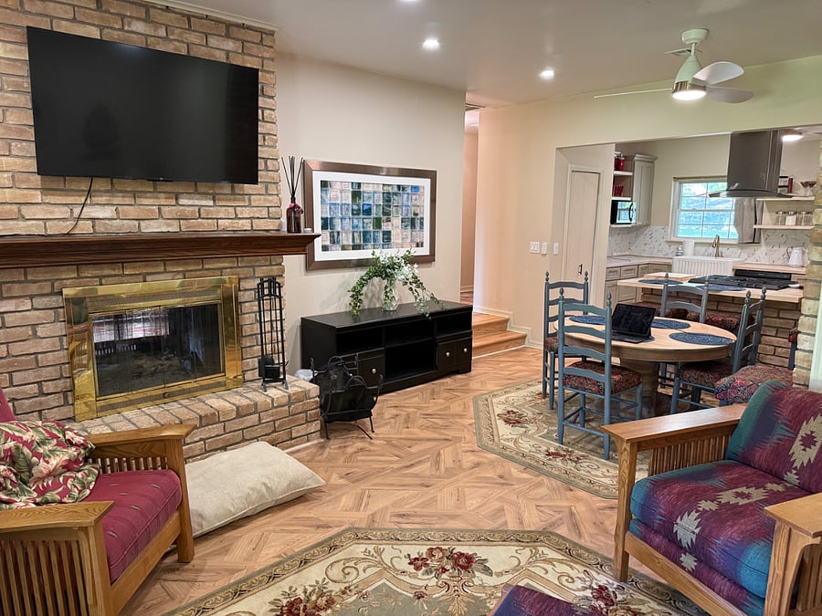 Open Dining and Family Room with wood Burning Fireplace.
