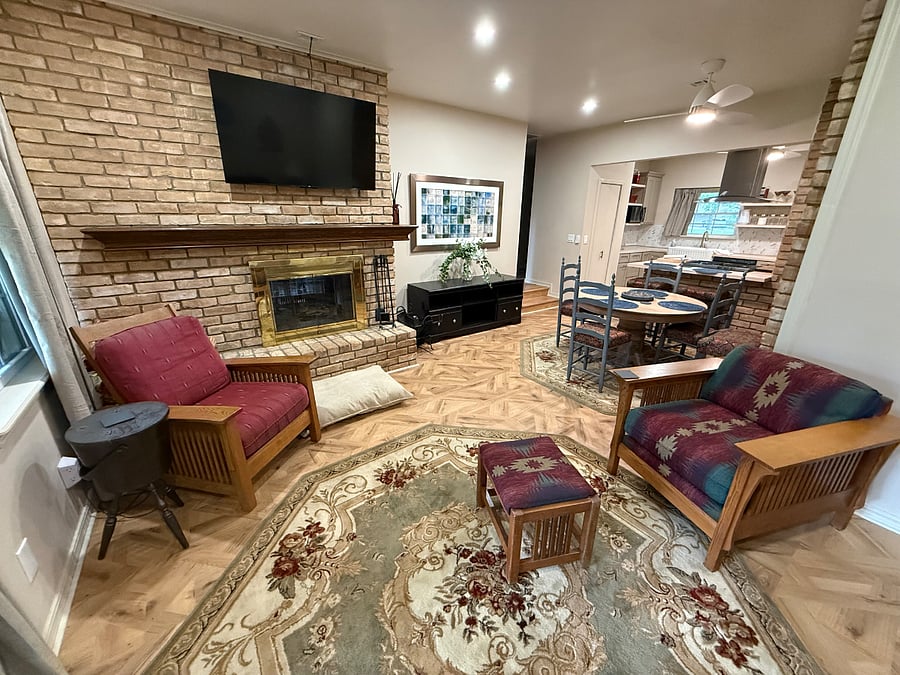 Open Family area, Living, dining and Kitchen. 55" Smart TV, Woodburning Fireplace shared with Formal living room. Acess to Patio.