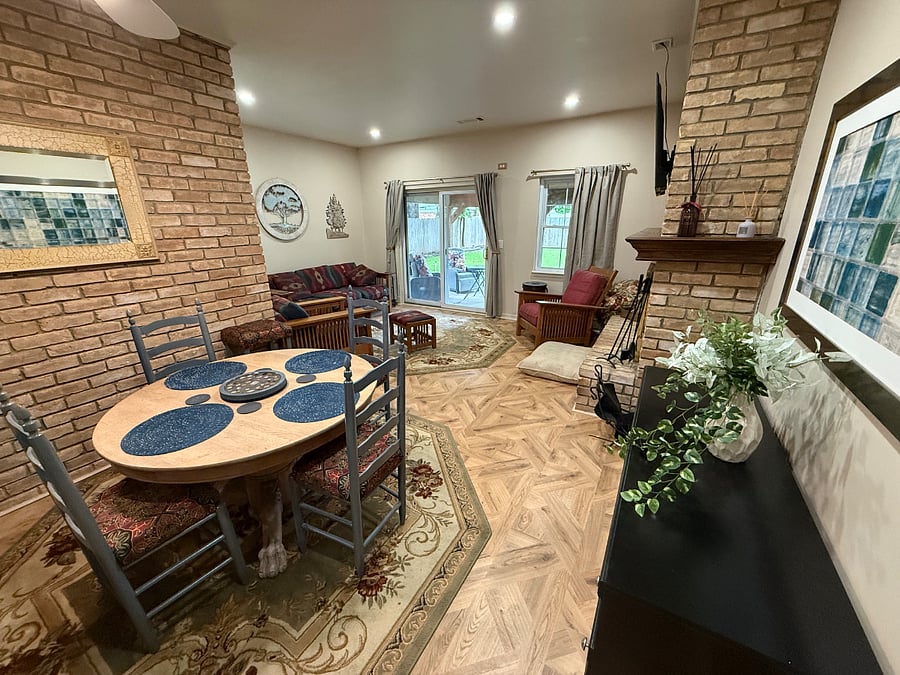 Open Family area, Living, dining and Kitchen. 55" Smart TV, Woodburning Fireplace shared with Formal living room. Acess to Patio.