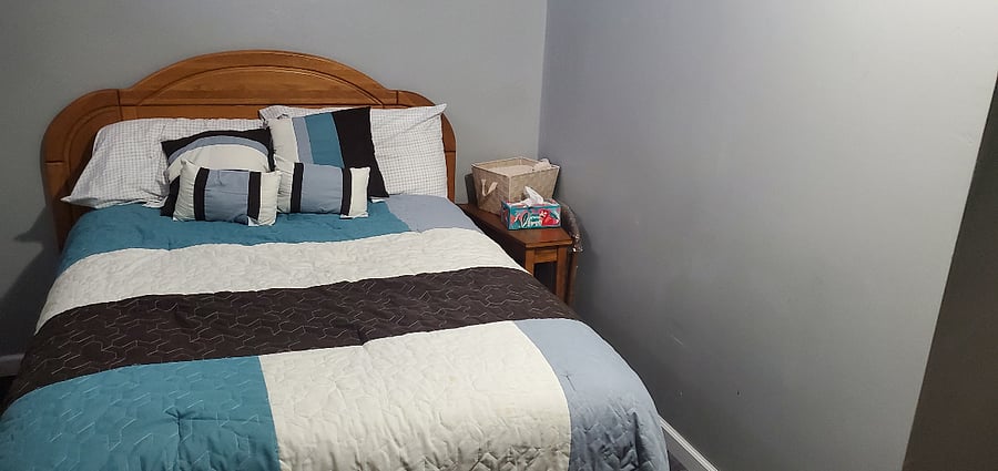 Full sized bed in the bedroom.