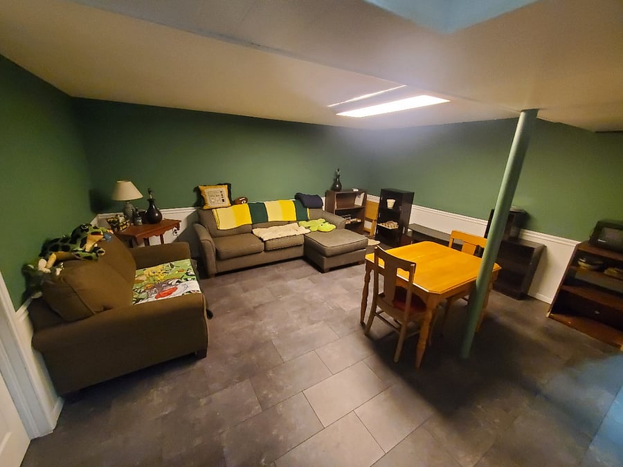 The den features, a tv, table and chairs, and comfortable seating.