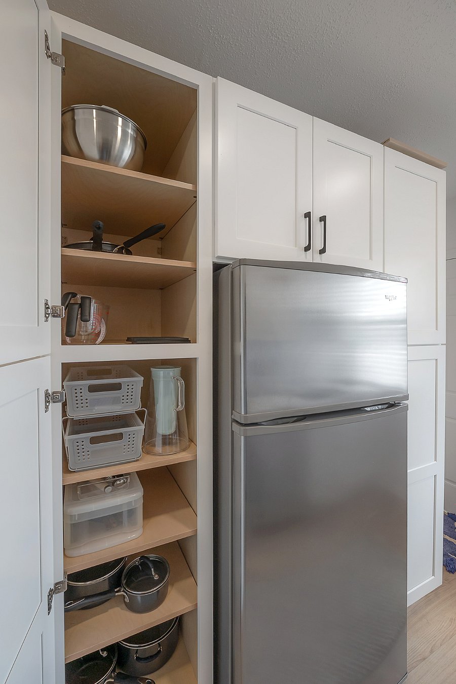 Fully renovated and stocked kitchen with gas range, microwave, dishwasher, refrigerator, and stackable washer and gas dryer