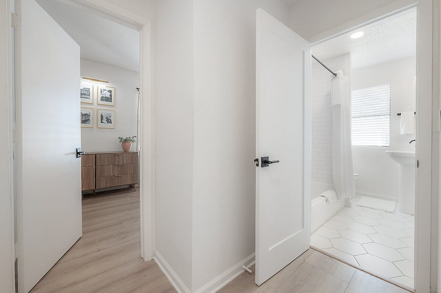 Primary bedroom at the back of the house (left) and full bathroom (right)