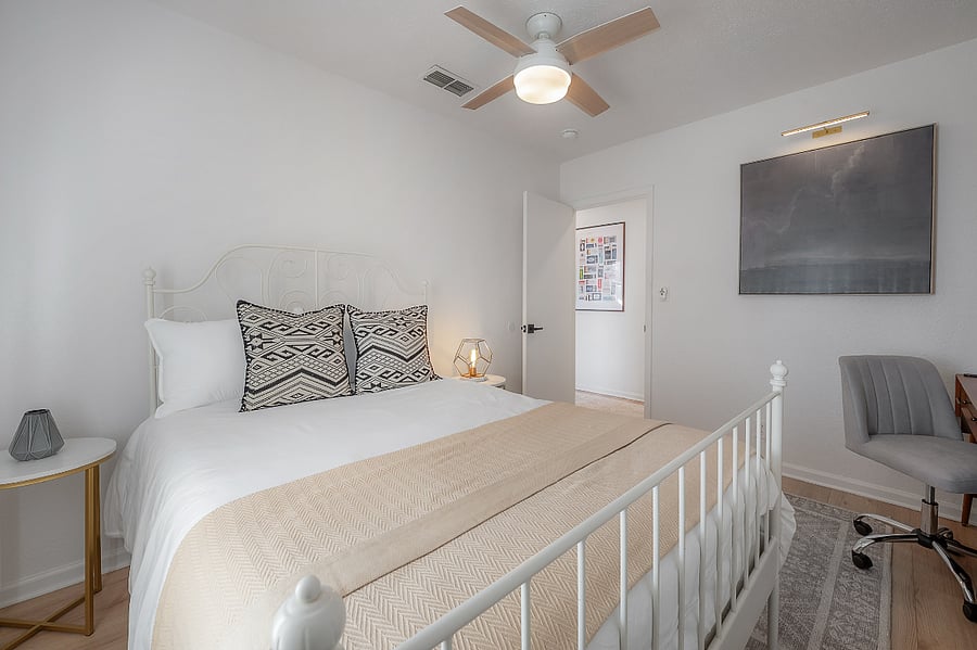 Guest bedroom with full sized bed, closet, and West Elm desk and office chair