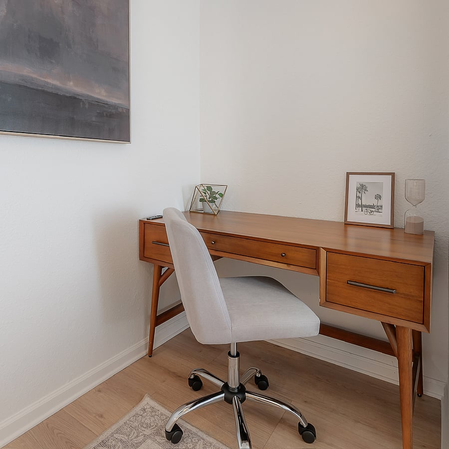 Guest bedroom with full sized bed, closet, and West Elm desk and office chair