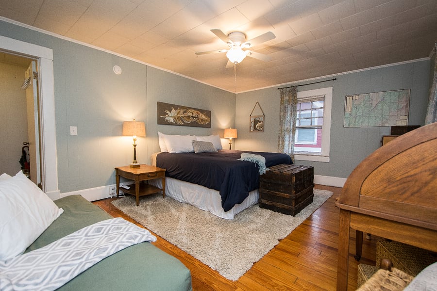 huge well furnished primary bedroom with big newer TV, ceiling fan, comfy king size bed  