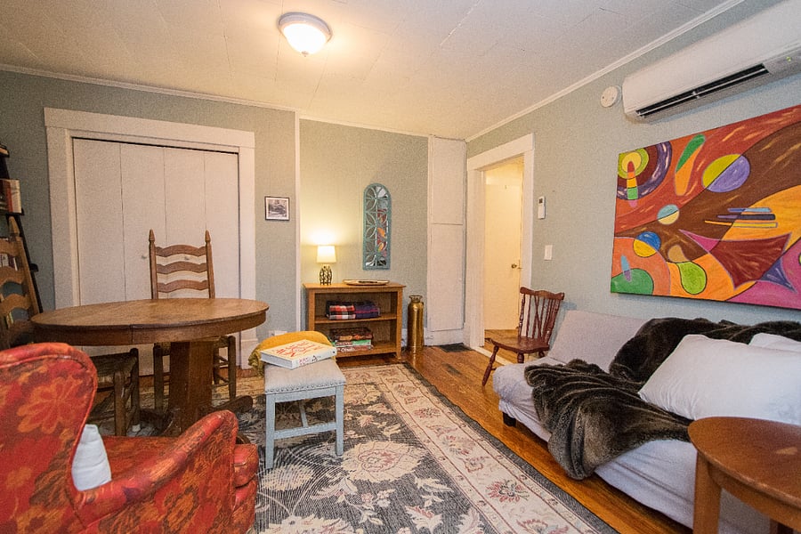 comfy living room has full size oak table that seated four