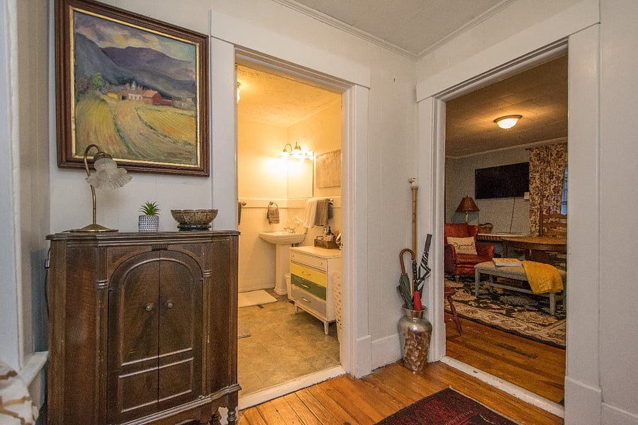lovely upper foyer with cool antique radio and Morrocan rug