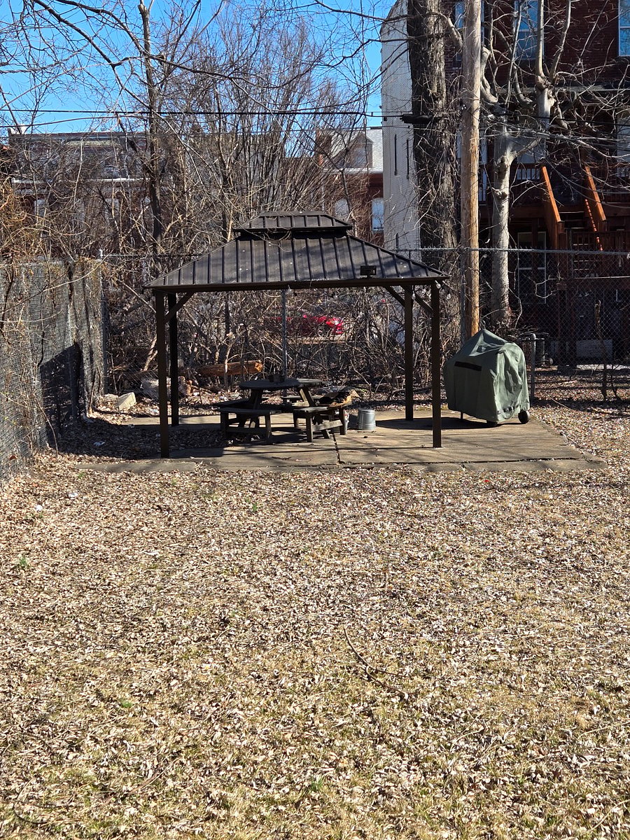Backyard, gazebo, table, and barbecue grill to be shared with other residents