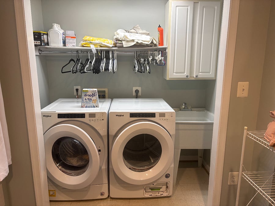 Washer/dryer and utility sink. 