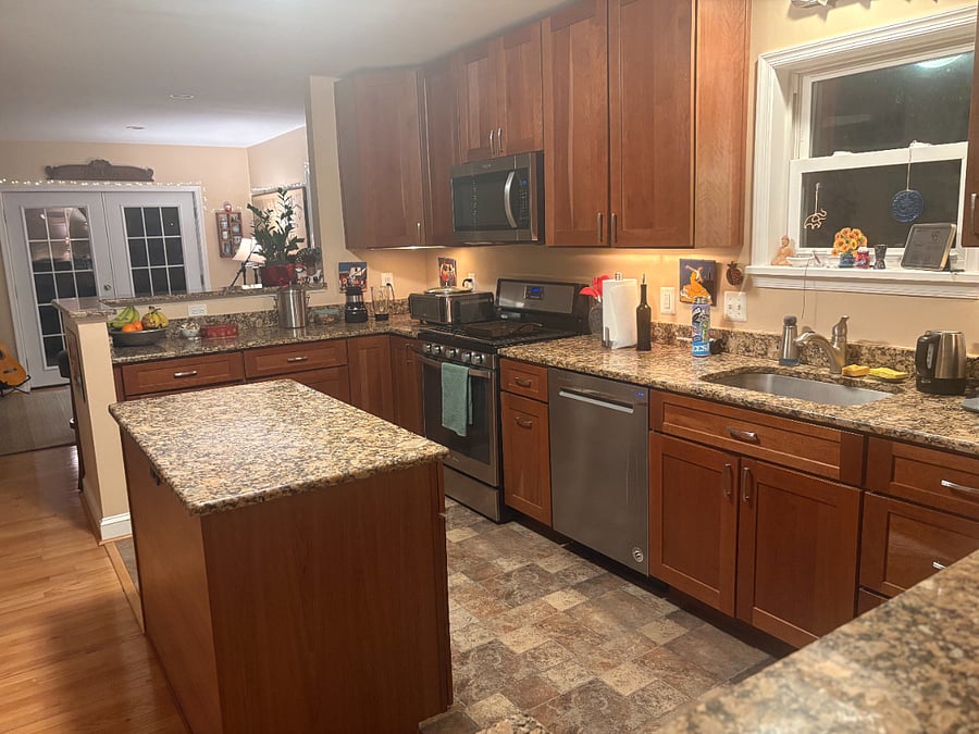 Another view of the shared kitchen with oven, microwave, air fryer, coffee maker, blender, tea kettle and all necessary items for cooking and eating.