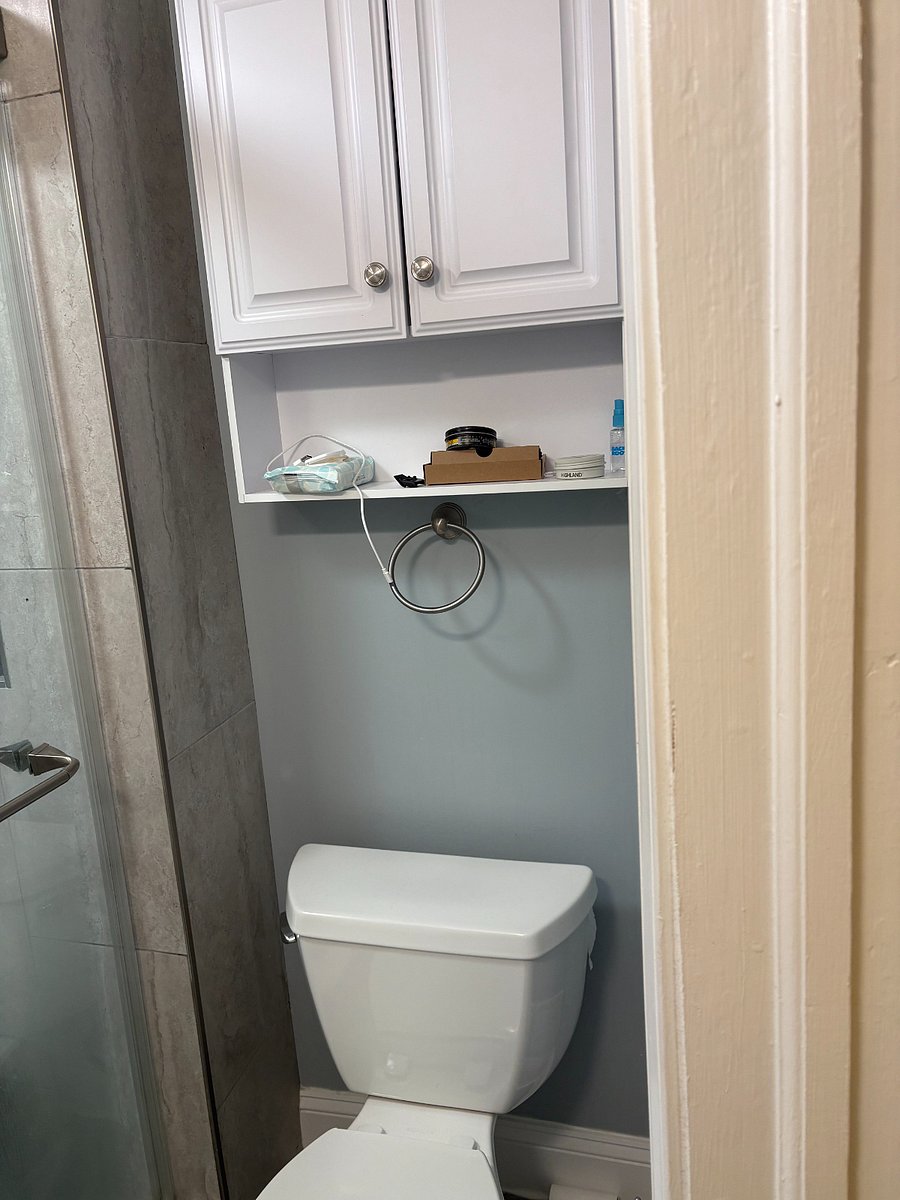 Shared bathroom on the 2nd floor toilet and shelving above the toilet.