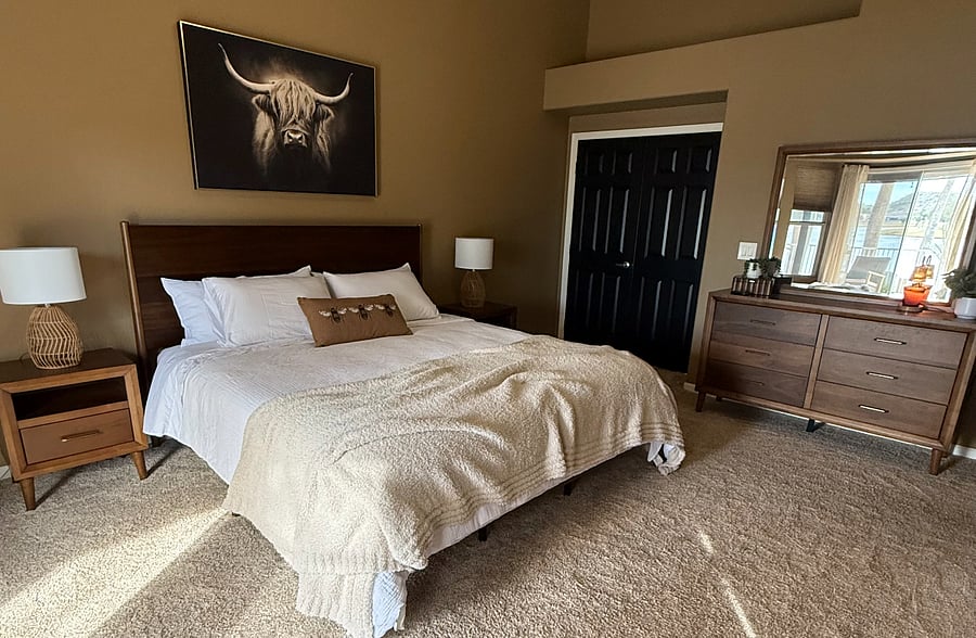 Primary bedroom with ensuite bathroom. King size bed.