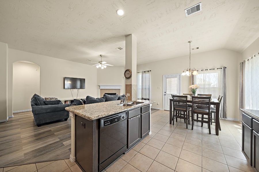 Open concept kitchen dining and living room space.