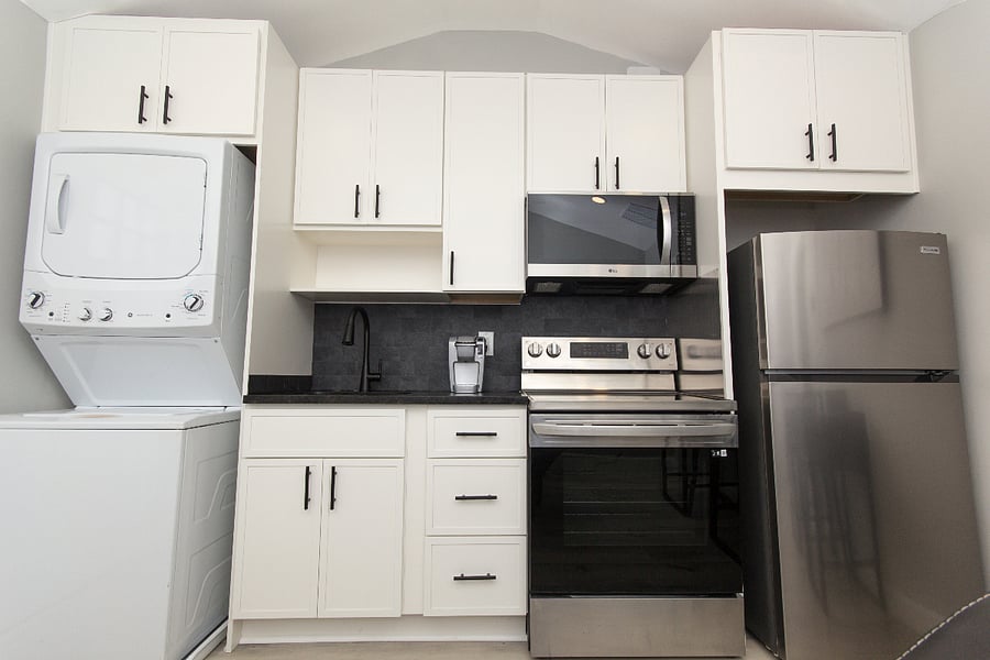 Full stocked kitchen w/ stainless appliances, granite countertops, soft-close cabinetry, and W/D.