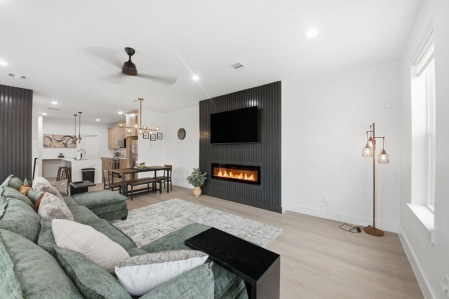 This inviting living space blends relaxation and everyday functionality, with comfortable seating, climate control, and natural light. The indoor fireplace creates a cozy atmosphere, while the TV and Wi-Fi support downtime and streaming. A dedicated workspace is thoughtfully placed for remote work or planning the day, and direct access to the balcony allows for easy indoor-outdoor flow.