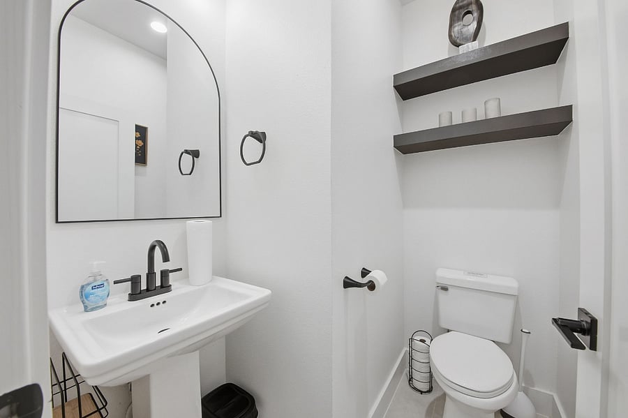 The half bathroom is conveniently located near the combined living and dining area and includes hot water, offering an easily accessible and functional space for guests.