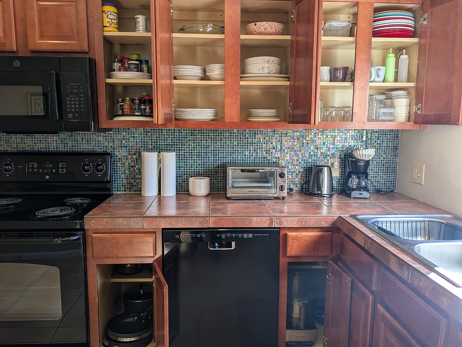 There are plenty of dishes, utensils, glassware, cookware, food storage, and extra small appliances like a food processor.