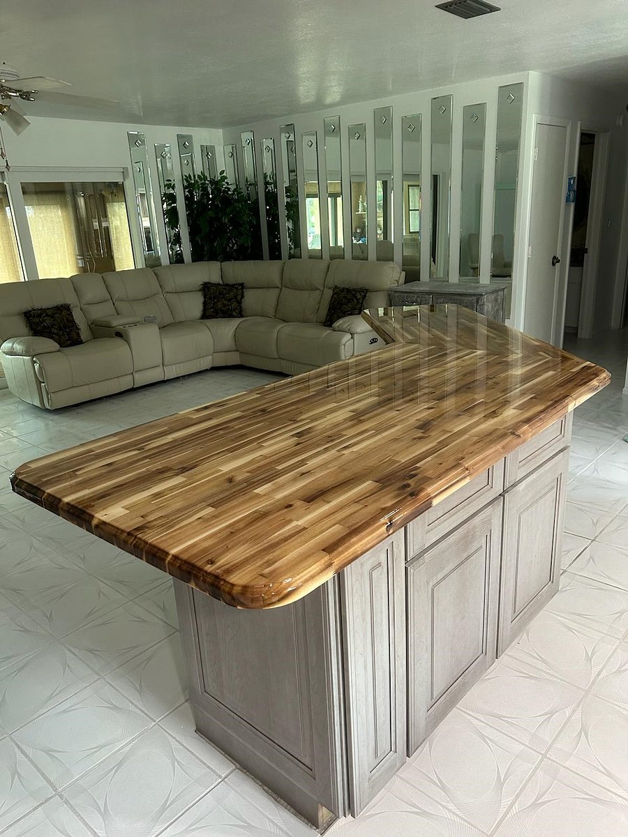 Butcher block island with counter top seating.. cupboard and drawers below