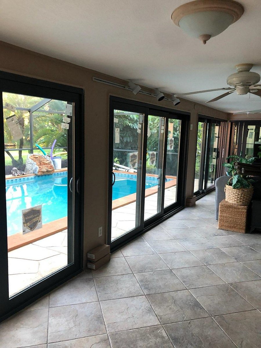 Lanai area with 4 sliding glass doors with sliding glass doors to enter into living room area 