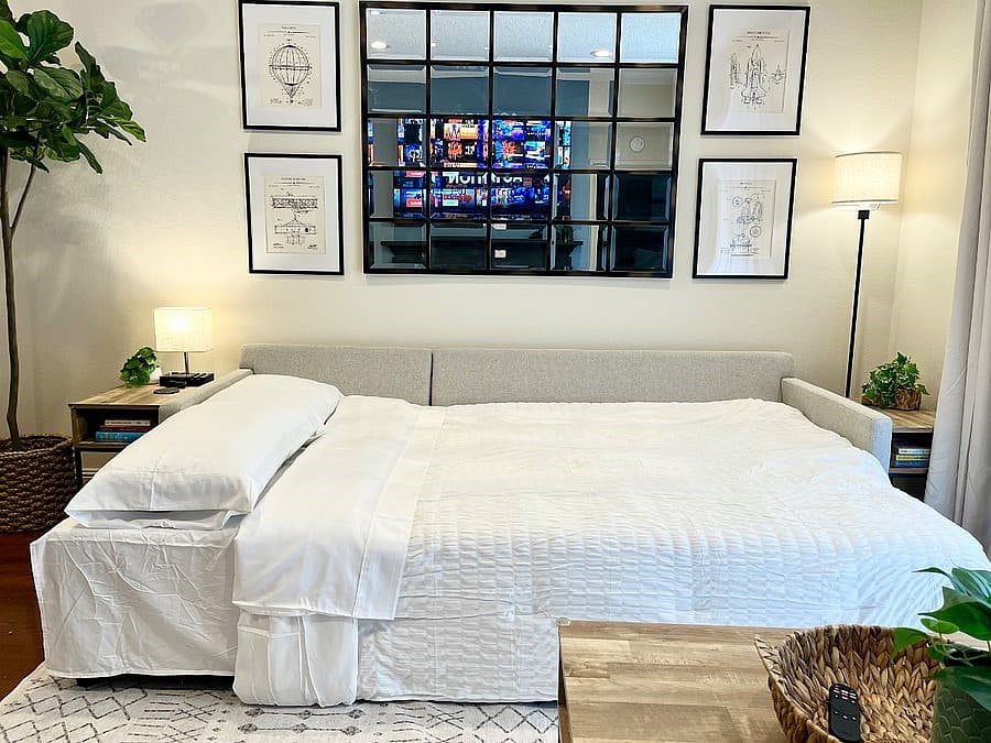 New Pottery Barn slipcovered sectional with a pull-out trundle to create a Queen-sized additional sleeping space for extra guests.