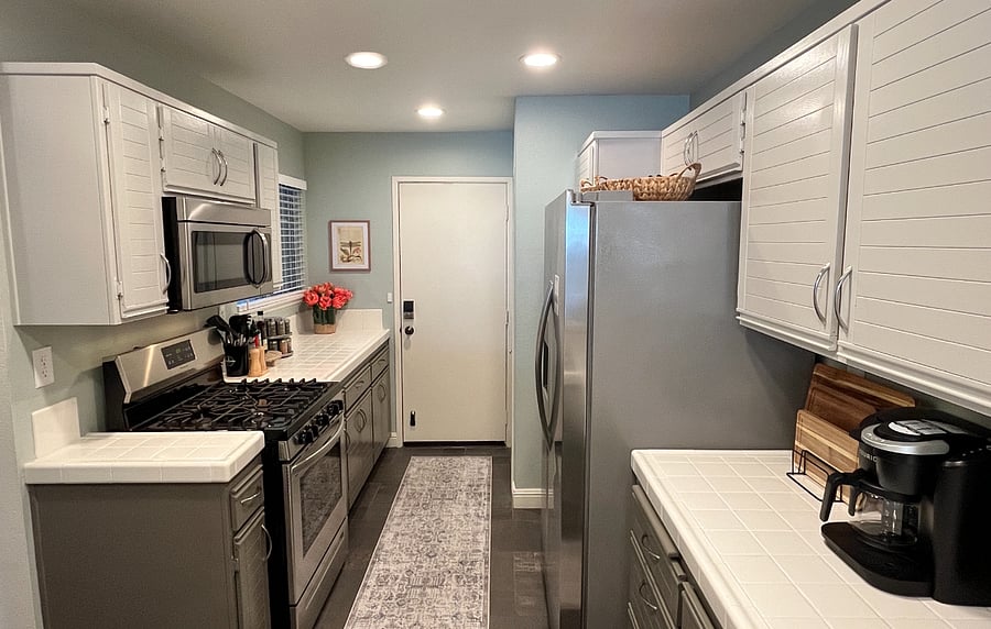 Spacious, fully equipped kitchen with direct access to the attached garage and additional carport conveniently located across from the garage.