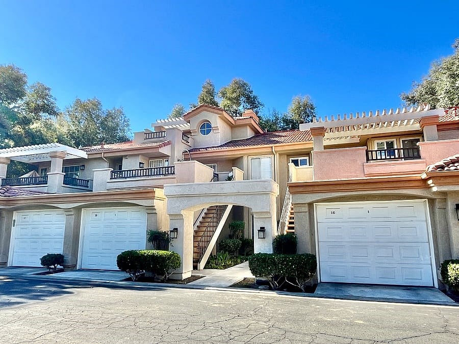 Ground-level unit in a Spanish resort style building, featuring stair-free living and private access from the attached garage with remote-control entry.