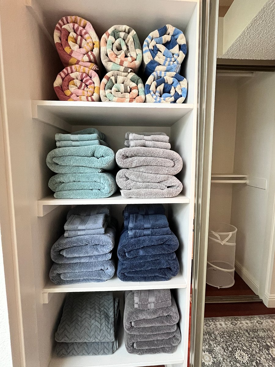 Spacious linen closet stocked with plush towels for five guests, extra pool towels, and soft hair-drying towels combining convenience with a touch of luxury.