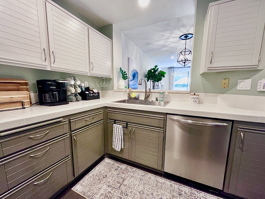 Spacious fully equipped kitchen with beverage bar, farmhouse sink, and large dishwasher.