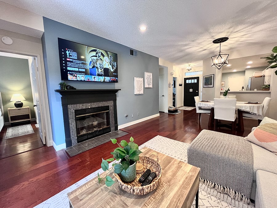 Completely ground-level with no stairs or carpet, this elegant living and dining area for up to 6 guests flows into the kitchen and outdoor living area, featuring a 65" Smart TV, gas fireplace, and a new Pottery Barn slipcovered sectional with a pull-out trundle to create additional lounging or sleeping space.