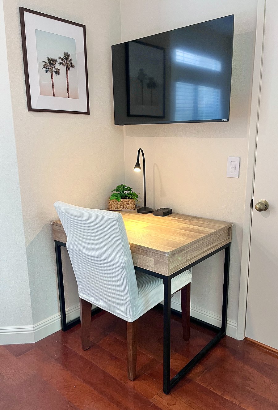 Spacious workstation with desk light, ample table space, convenient outlet, and comfy chair perfect for work or giving kids a dedicated homework space.