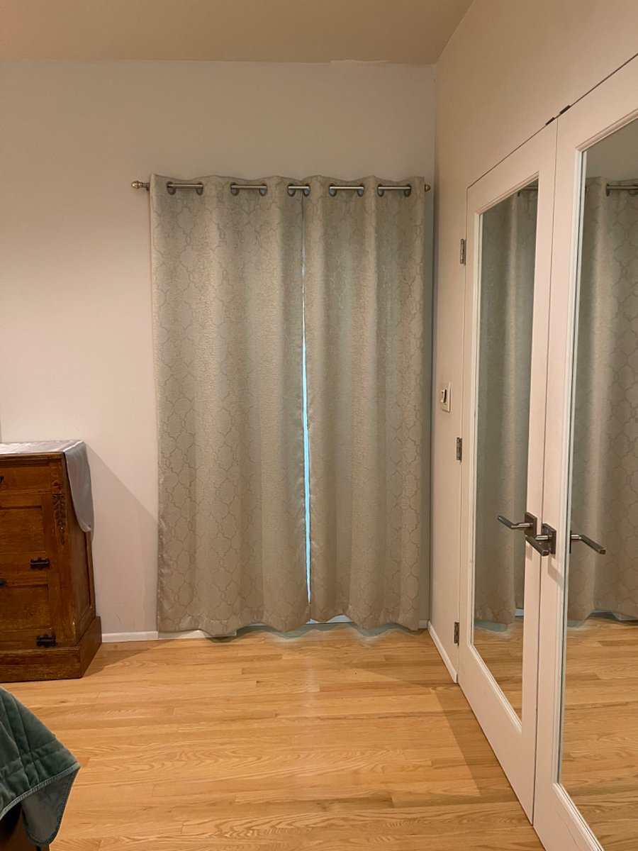 Doorway to rear entry with black-out curtains.