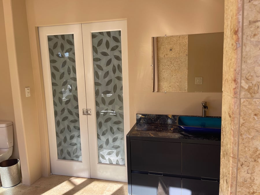 Glass entry doors to master bedroom.