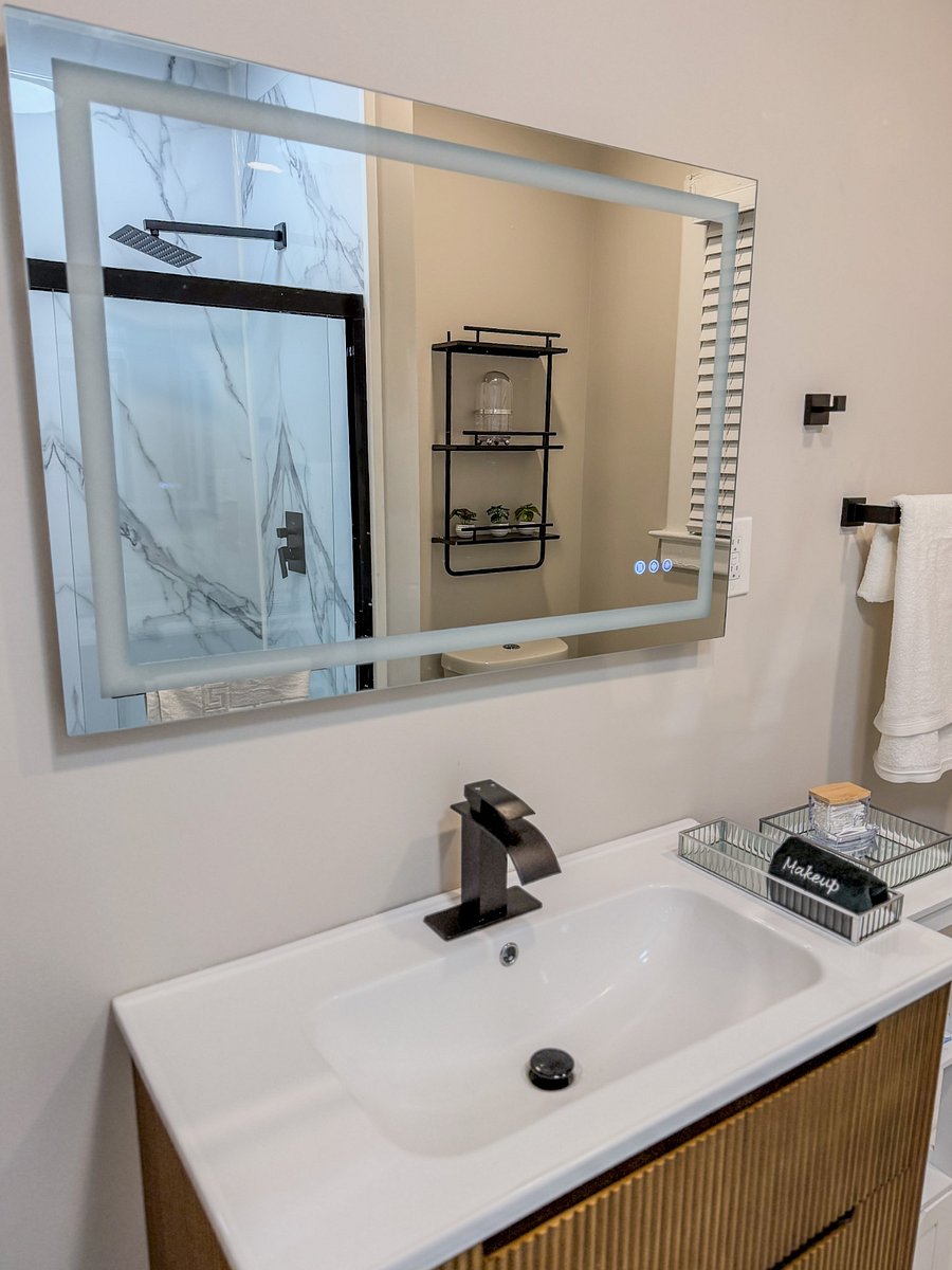 Full bathroom with LED mirror featuring anti-fog and even lighting.
