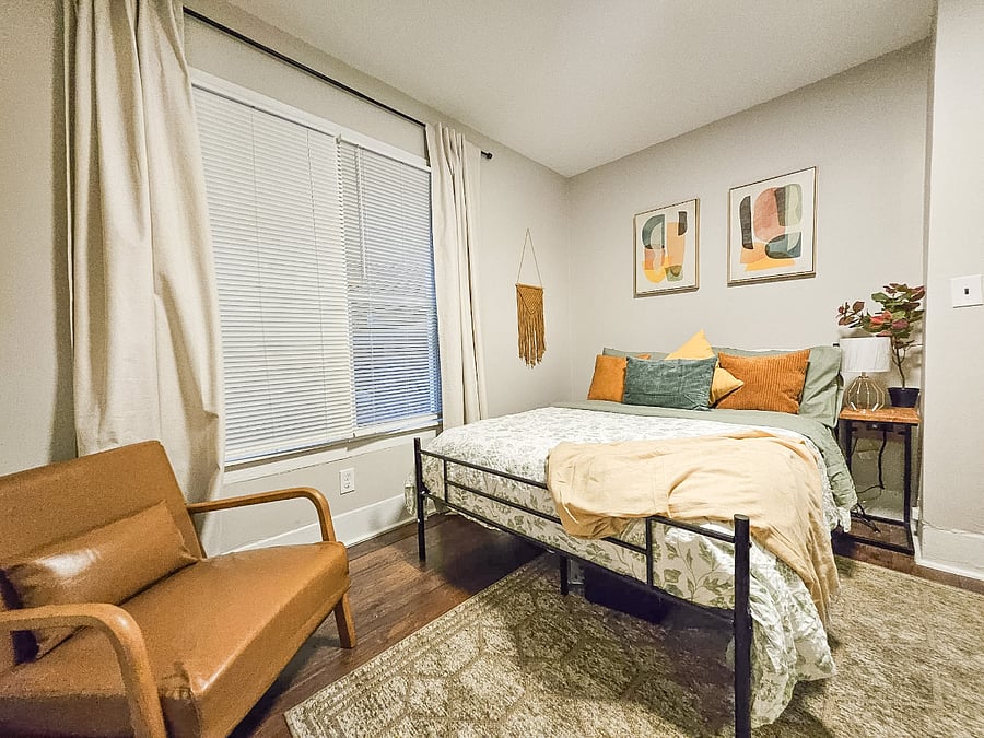 Guest bedroom with a cozy bed, 43 smart TV, dresser, walk-in closet, and nightstands with convenient charging stations.