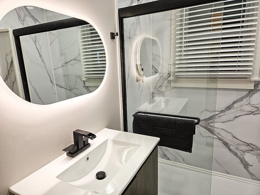 Updated bathroom with an anti-fog vanity mirror and even lighting for a clear, comfortable start to your day.