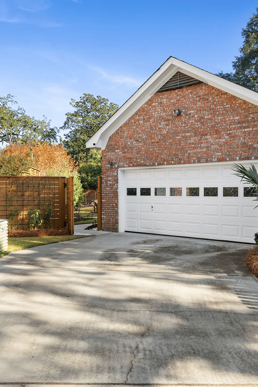 Access to garage and backyard via side driveway.