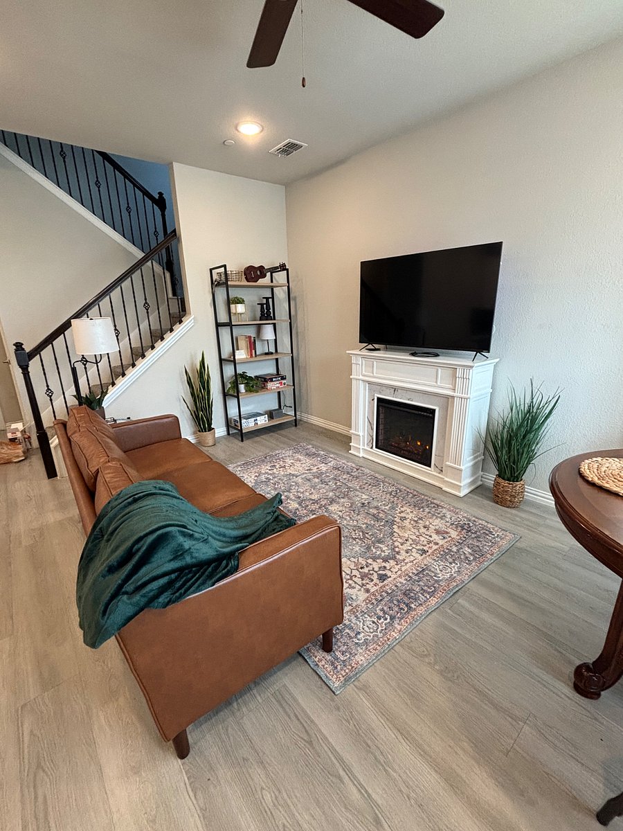 Living room with fireplace and 55 inch TV.