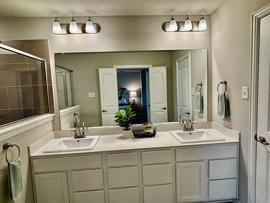 Primary bathroom double sinks with large vanity.
