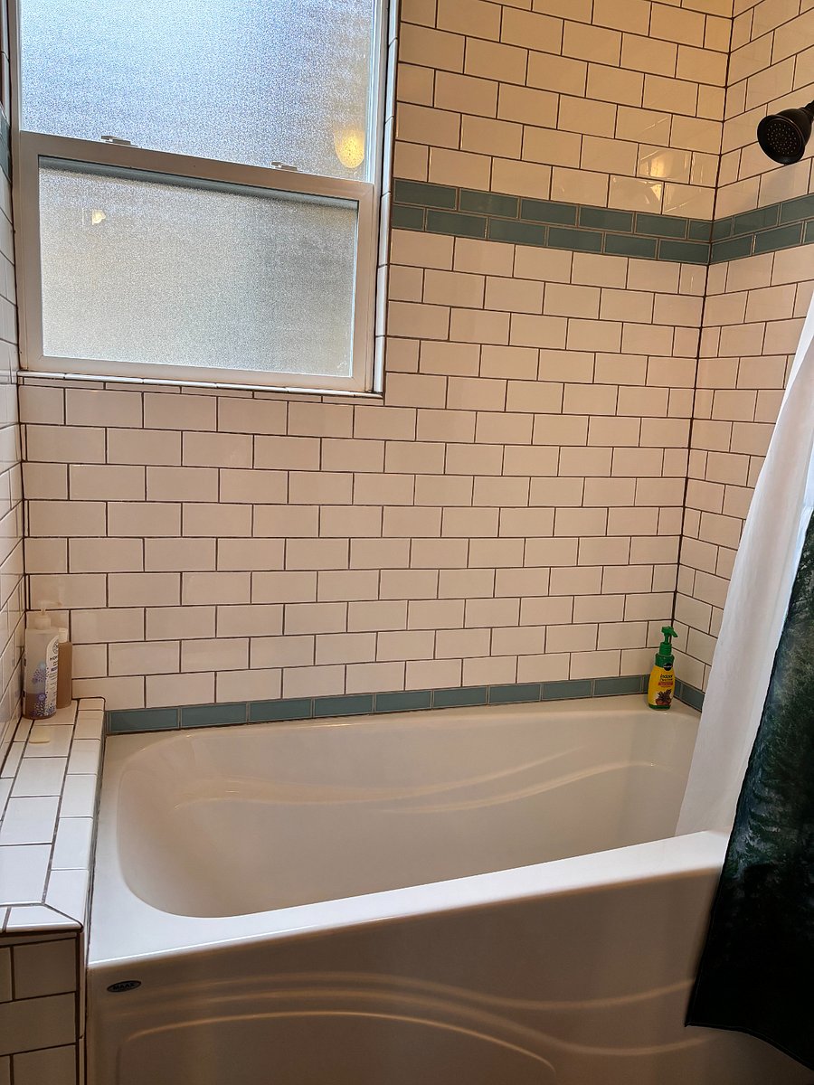 Tiled tub/shower in the recently remodelled bathroom.
