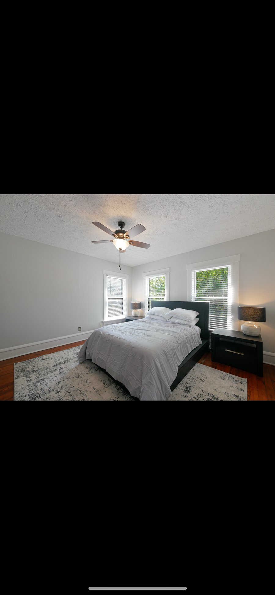 Primary bedroom with tons of natural light, equipped with full-sized wardrobe and closet.