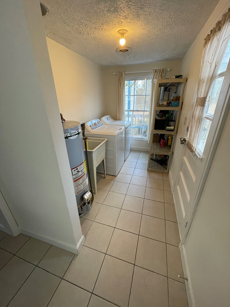 Laundry - full size washer/dryer. Ironing board/iron. Extra storage shelves. Mud sink, door to back deck.