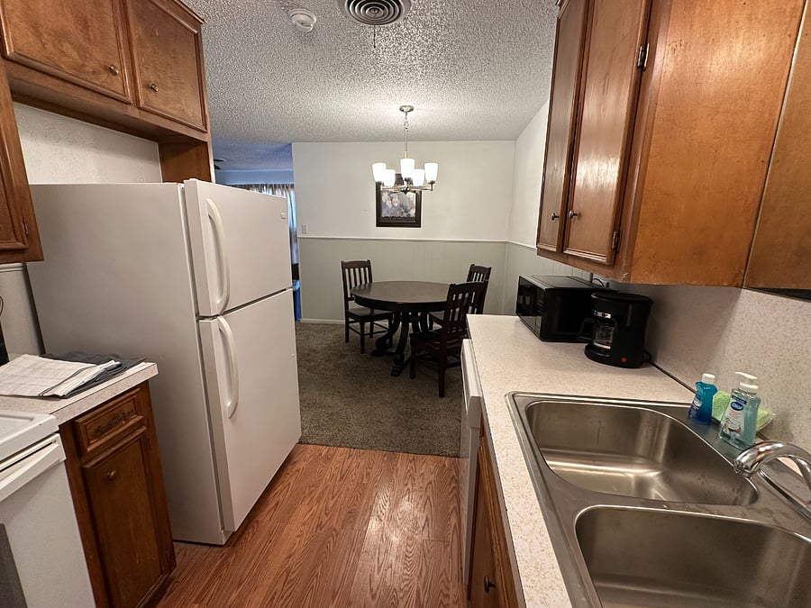 Kitchen with dishes, cookware, spices, microwave, coffee maker