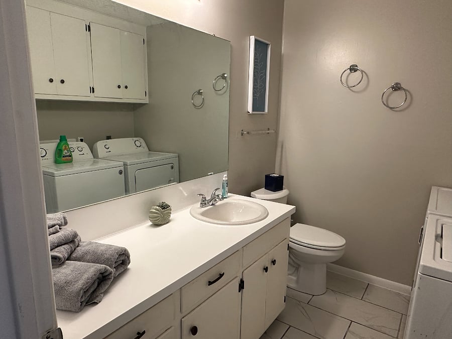 Back bathroom with shower and washer dryer