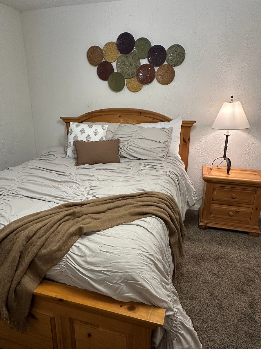 Back bedroom with queen bed, separate entrance to carport, walk in closet